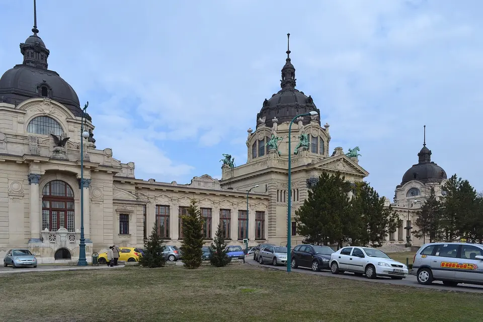 Steaming outdoor thermal pool at Széchenyi Baths in Budapest with its yellow baroque facade