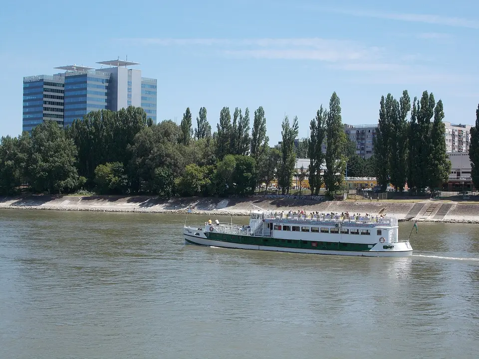 Sightseeing boat leaving the Vigadó tér dock on the Danube with Buda Castle behind