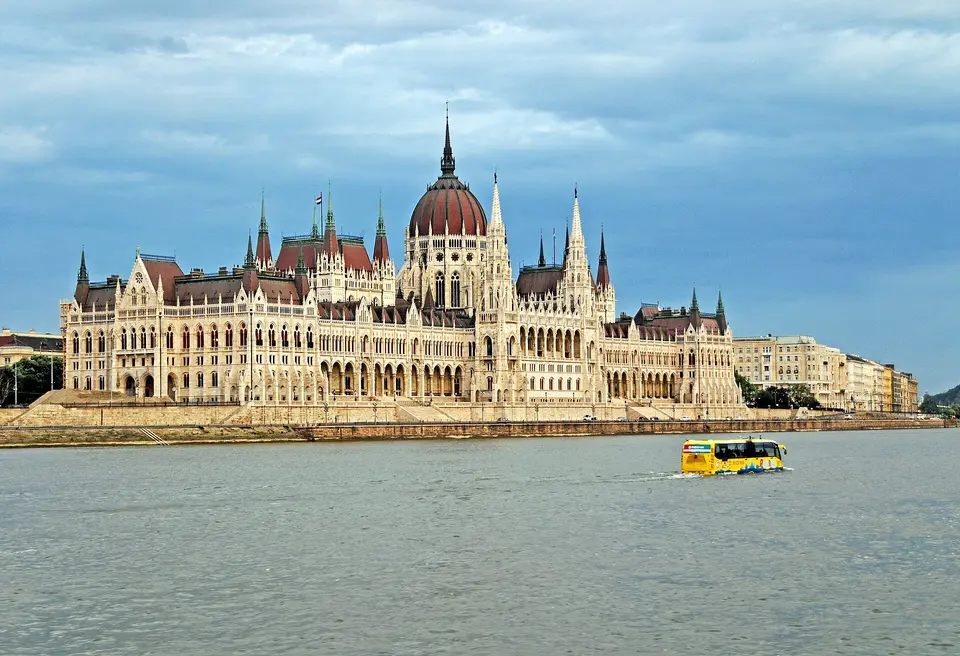 Sightseeing boat passing the illuminated Hungarian Parliament on the Danube in Budapest at night