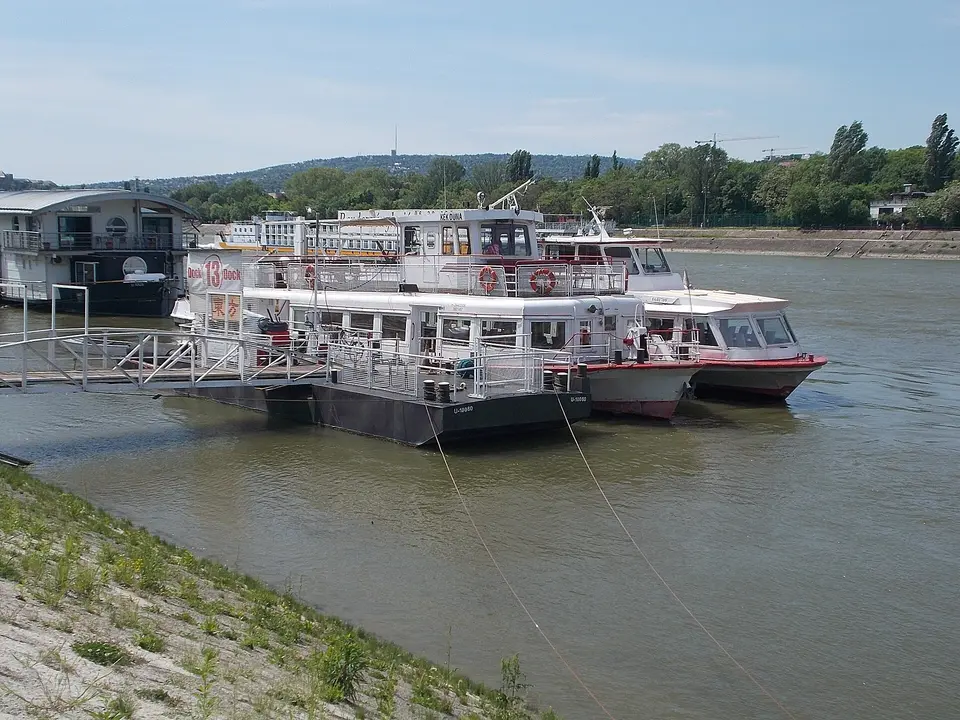 Sightseeing boats from several operators lined up along the Pest embankment docks in Budapest