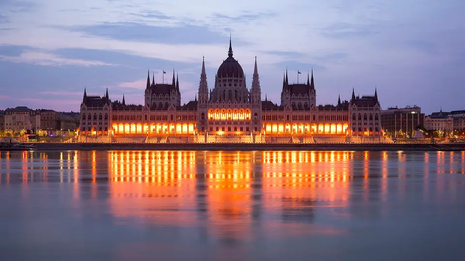 The illuminated Hungarian Parliament building reflected in the Danube at night